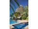 Condo building overlooks pool and lush landscaping at 435 L Ambiance Dr # L807, Longboat Key, FL 34228