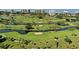 Scenic aerial view of a lush green golf course with ponds, trees, and manicured lawns at 435 L Ambiance Dr # L807, Longboat Key, FL 34228