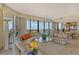 Luxurious living room with floor-to-ceiling windows, elegant furnishings, and stunning city views at 435 L Ambiance Dr # L807, Longboat Key, FL 34228