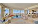 Luxurious living room with floor-to-ceiling windows, elegant furnishings, and stunning city views at 435 L Ambiance Dr # L807, Longboat Key, FL 34228