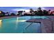Inviting pool area with palm trees at twilight at 435 L Ambiance Dr # L807, Longboat Key, FL 34228