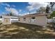 Fenced backyard with lawn and a storage shed at 445 88Th N Ave, St Petersburg, FL 33702