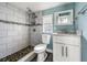 Stylish bathroom with stone pebble shower floor and modern white vanity at 445 88Th N Ave, St Petersburg, FL 33702