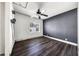 Bedroom with dark accent wall, wood-look flooring, and ceiling fan at 445 88Th N Ave, St Petersburg, FL 33702