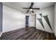 Bedroom with ceiling fan, wood-look flooring, and doorways to other rooms at 445 88Th N Ave, St Petersburg, FL 33702