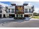 Contemporary townhome with drive-under garage, rooftop deck access via spiral stair, and central palm tree at 445 88Th N Ave, St Petersburg, FL 33702