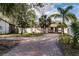 Charming home featuring a brick driveway, well-kept lawn, and a cozy front porch at 445 88Th N Ave, St Petersburg, FL 33702