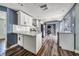 Modern kitchen with white cabinets, stainless steel appliances, and a stylish backsplash at 445 88Th N Ave, St Petersburg, FL 33702