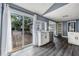 Kitchen view with white cabinets, stainless steel appliances, and access to a lovely outdoor deck at 445 88Th N Ave, St Petersburg, FL 33702