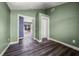Room with wood-look floors and doorways to other rooms at 445 88Th N Ave, St Petersburg, FL 33702