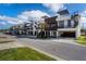 Street view of modern townhomes boasting rooftop decks, spiral staircases, convenient garages, and landscaped features at 445 88Th N Ave, St Petersburg, FL 33702