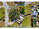 Aerial view of a single-story home with a well-manicured lawn and mature trees in a quiet neighborhood at 4808 29Th W Ave, Bradenton, FL 34209