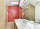 Modern bathroom showcasing a vanity with white countertop, decorative mirrors, and tile flooring at 4920 82Nd E Pl, Sarasota, FL 34243