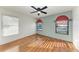 Comfortable bedroom with wood floors, a ceiling fan, large window and natural light at 4920 82Nd E Pl, Sarasota, FL 34243
