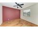 Bright bedroom with wood floors, a ceiling fan, a window and natural light at 4920 82Nd E Pl, Sarasota, FL 34243