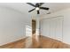 Bright bedroom with wood floors, a ceiling fan, closet doors and natural light at 4920 82Nd E Pl, Sarasota, FL 34243