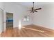 Bright bedroom featuring wood floors, ceiling fan, and natural light from a window, creating a cozy atmosphere at 4920 82Nd E Pl, Sarasota, FL 34243