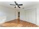 Spacious bedroom featuring wood floors, a ceiling fan, closet doors and natural light at 4920 82Nd E Pl, Sarasota, FL 34243