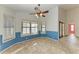 Bright dining room featuring tile floors, a ceiling fan, and access to the hallway at 4920 82Nd E Pl, Sarasota, FL 34243