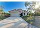 Well-maintained single-Gathering home with a long driveway and lush landscaping at 4920 82Nd E Pl, Sarasota, FL 34243