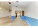 Open-concept kitchen featuring tile floors, wooden cabinets, and access to the living room at 4920 82Nd E Pl, Sarasota, FL 34243