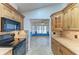 Open kitchen featuring wood cabinetry, granite countertops, and stainless steel appliances at 4920 82Nd E Pl, Sarasota, FL 34243