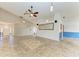 Spacious living area featuring tile floors, ceiling fan, and open layout at 4920 82Nd E Pl, Sarasota, FL 34243