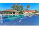 Community swimming pool with a covered pavilion and lounge chairs for residents' enjoyment at 4920 82Nd E Pl, Sarasota, FL 34243