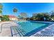 Community swimming pool featuring a clear blue expanse, lounge chairs, and lush tropical landscaping at 4920 82Nd E Pl, Sarasota, FL 34243