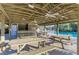 Community pool pavilion with picnic tables, ceiling fans, and a bar area perfect for outdoor gatherings at 4920 82Nd E Pl, Sarasota, FL 34243