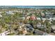 Beautiful aerial view of a property with a pool, surrounded by lush landscaping and waterfront access at 5107 Saint Albans Ave, Sarasota, FL 34242