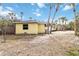 Large backyard with tropical plants and yellow house at 5107 Saint Albans Ave, Sarasota, FL 34242