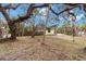 Spacious backyard with mature trees and landscaping at 5107 Saint Albans Ave, Sarasota, FL 34242