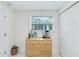 Neutral bedroom with a closet, large window, and blond wood dresser at 5107 Saint Albans Ave, Sarasota, FL 34242