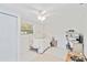 Bright bedroom with a large window, white walls and floors, and fan lighting at 5107 Saint Albans Ave, Sarasota, FL 34242