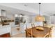 Bright dining area with wooden furniture near an open kitchen with stainless steel appliances at 5107 Saint Albans Ave, Sarasota, FL 34242