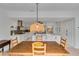 Open floor plan featuring a dining area and a modern kitchen with white cabinetry and an island at 5107 Saint Albans Ave, Sarasota, FL 34242