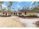 Charming single-story home featuring a well-maintained lawn, beautiful plants, and a welcoming entrance at 5107 Saint Albans Ave, Sarasota, FL 34242