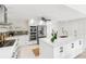 Modern kitchen with white cabinets, stainless steel appliances, and a center island with a sink at 5107 Saint Albans Ave, Sarasota, FL 34242