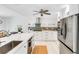 Stylish kitchen with white cabinets, quartz countertops, stainless appliances, and a center island at 5107 Saint Albans Ave, Sarasota, FL 34242