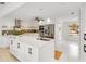Bright kitchen featuring white cabinets, stainless steel appliances, and a spacious center island at 5107 Saint Albans Ave, Sarasota, FL 34242