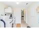 Bright laundry room featuring modern washer and dryer and storage cabinets at 5107 Saint Albans Ave, Sarasota, FL 34242
