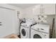 Bright laundry room featuring modern washer and dryer and storage cabinets at 5107 Saint Albans Ave, Sarasota, FL 34242