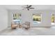 Bright living room with seating area overlooking a pool through large windows at 5107 Saint Albans Ave, Sarasota, FL 34242