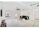 Bright living room with modern lighting, a green sofa, and a decorative ceiling fan at 5107 Saint Albans Ave, Sarasota, FL 34242