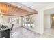 Bright home office with a wood beam ceiling, tile floor and large windows at 5107 Saint Albans Ave, Sarasota, FL 34242