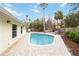 Beautiful pool area with outdoor dining and lounging space at 5107 Saint Albans Ave, Sarasota, FL 34242