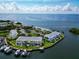 Aerial view of waterfront condos, showcasing boat docks, landscaping, and stunning water views at 5282 Beach Se Dr # D, St Petersburg, FL 33705