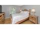 Cozy bedroom featuring a wooden bed frame and neutral decor at 5282 Beach Se Dr # D, St Petersburg, FL 33705