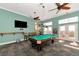 Spacious game room with a billiard table, ceiling fans, and neutral paint, offering a relaxing entertainment space at 5282 Beach Se Dr # D, St Petersburg, FL 33705
